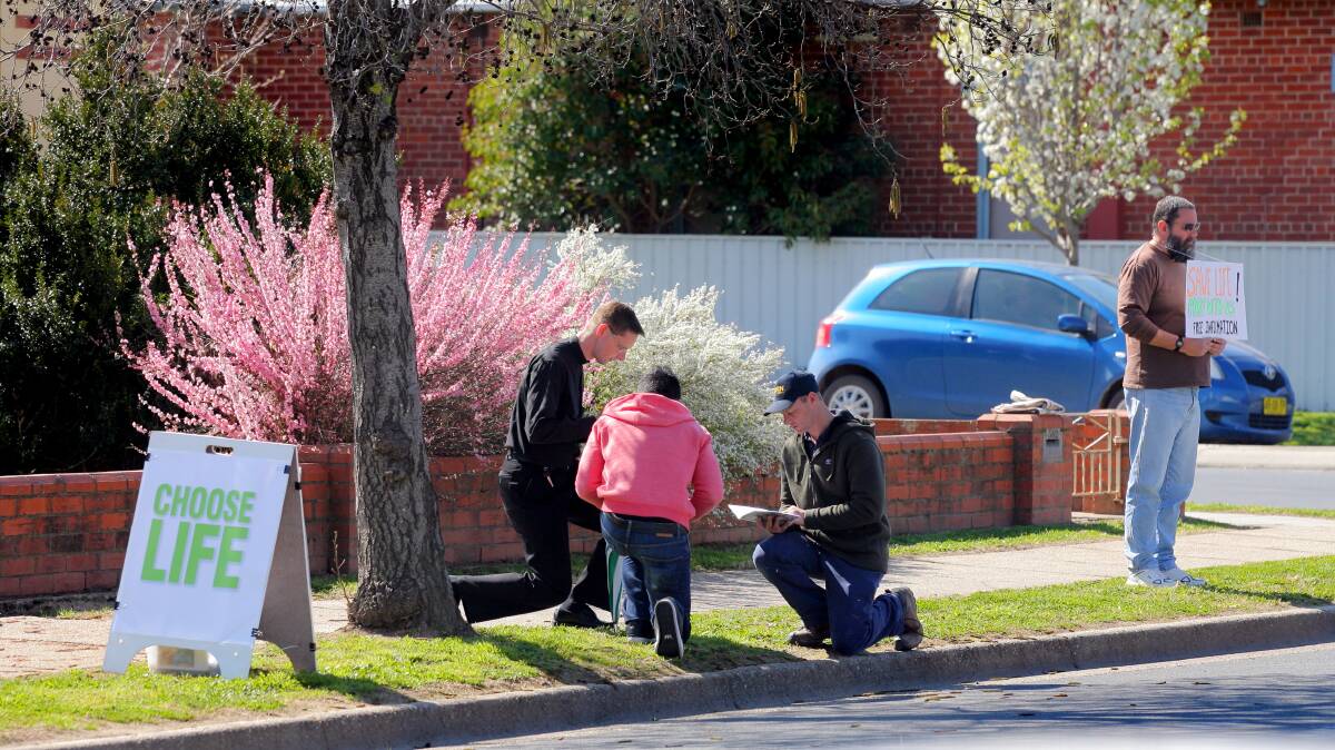 In prayer: Anti-abortion protesters the Engledhardt Street abortion clinic in Albury.