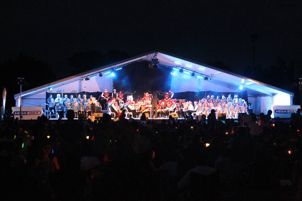 Don't stand so close: Wodonga's Carols by Candlelight stage in its full night-time glory. Physical distancing and the fallout from COVID-19 will alter the format of this year's event in some manner.