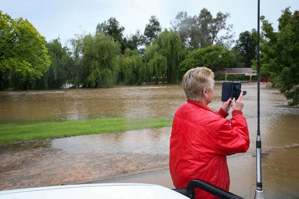Up, up, up: The Ten Mile Creek at Holbrook swelled on Friday, covering the miniature railway circuit. The site prompted passersby to grab a snap. Picture: JAMES WILTSHIRE