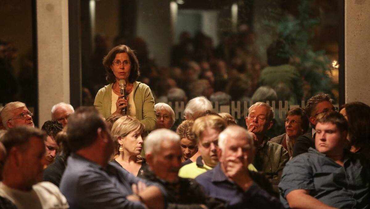 Putting a question: Climate change campaigner Lizette Salmon asks Liberal Steve Martin about his failure to include her issue on a list of important issues. Picture: JAMES WILTSHIRE