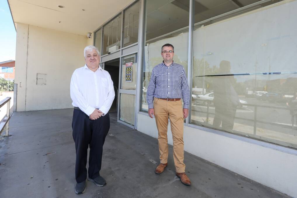 Jam to jabs: Kev Poulton and Michael Kalimnios stand at the old rear doors of the grocery which will be entrance to the vaccination clinic. Picture: TARA TREWHELLA