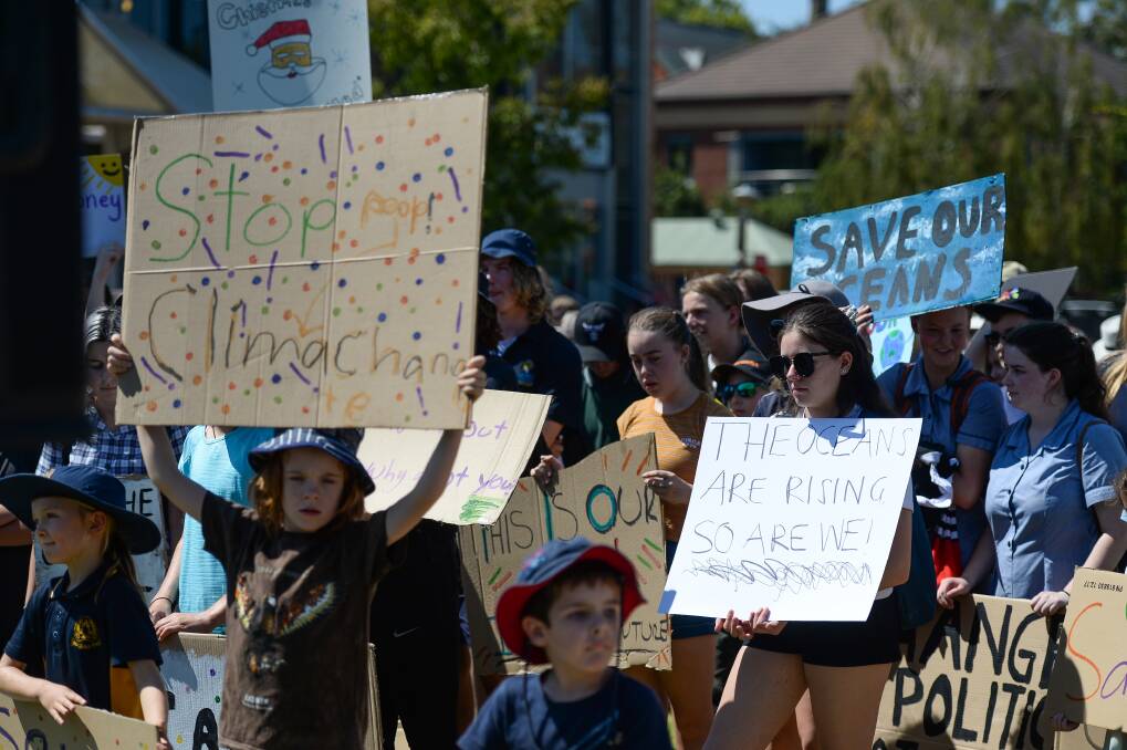 Flashback: School pupils hold up placards at Albury's QEII Square in March at a climate strike rally. Picture: MARK JESSER