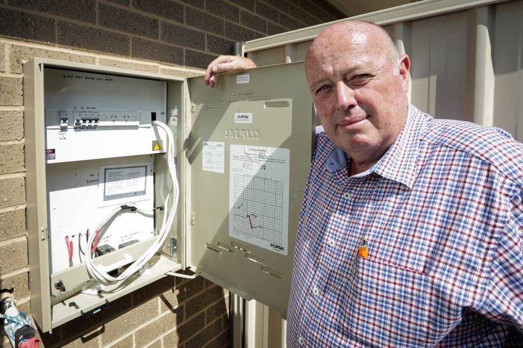 Feeling zapped: Doug Sanderson with the electricity box at his Bandiana home which is not working because of an industrial dispute. Picture: JAMES WILTSHIRE