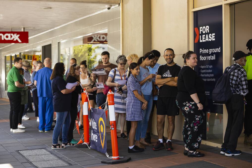 Voters line up along the footpath outside the Mate's Building in central Albury to fill out their early NSW election ballots. Picture by Ash Smith 