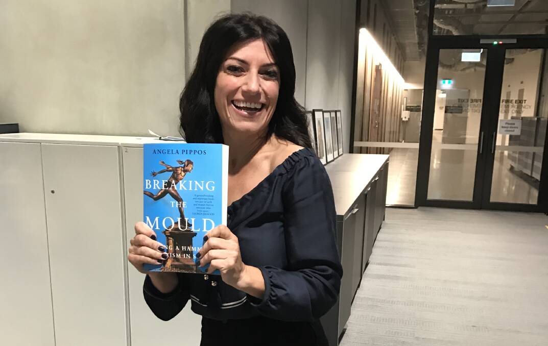 Telling their story: Angela Pippos with her book Breaking the Mould which relates the travails of women's sport in Australia. 