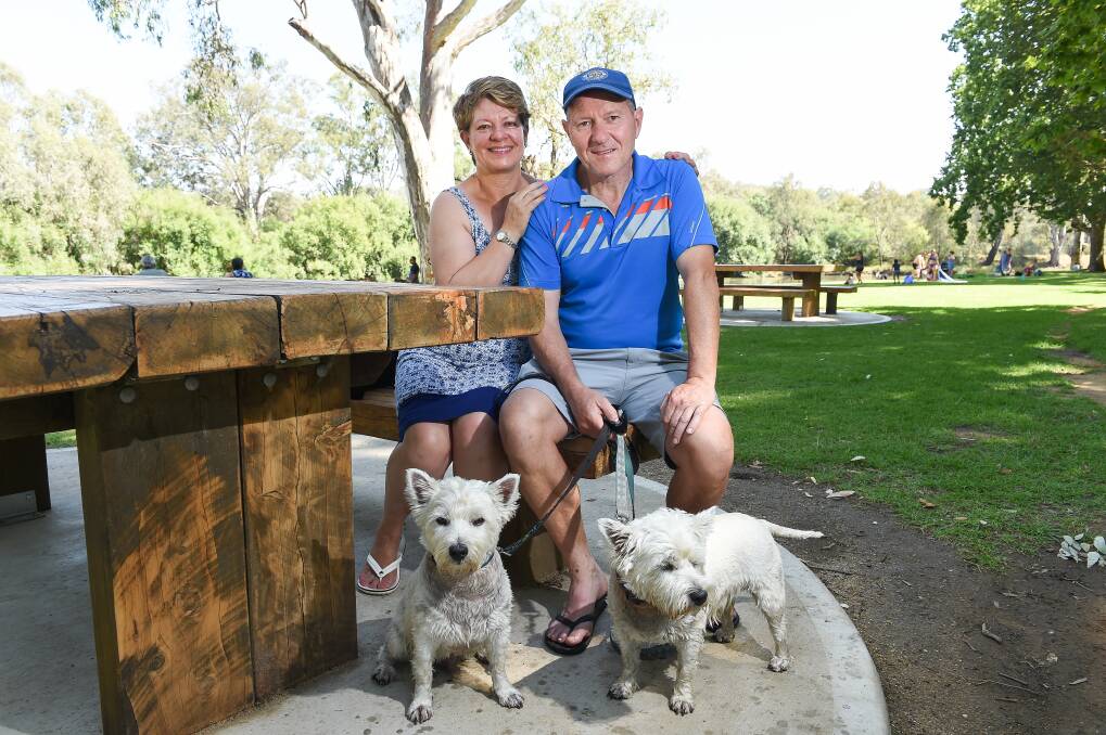 Happy with changes: Loretta and Tony Caunt with their terriers sit at one of the new tables set on concrete circles at Noreuil Park. Picture: MARK JESSER
