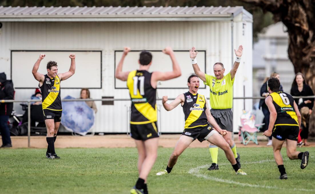 Reign continues: Osborne players celebrate their success in the 2019 Hume league grand final. The club will continue to be the premiership holders until 2021.