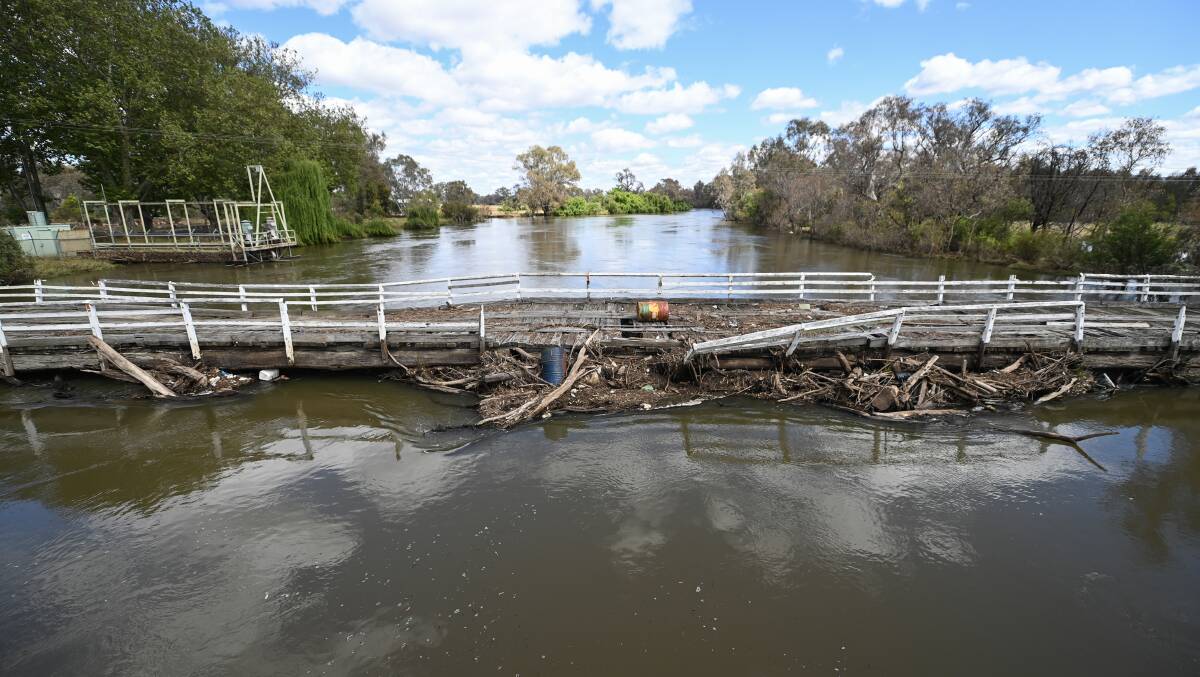 Flood debris has washed onto the deck and got stuck on Wodonga's historic stock bridge which has been shut to the public for a decade. Picture by Mark Jesser.