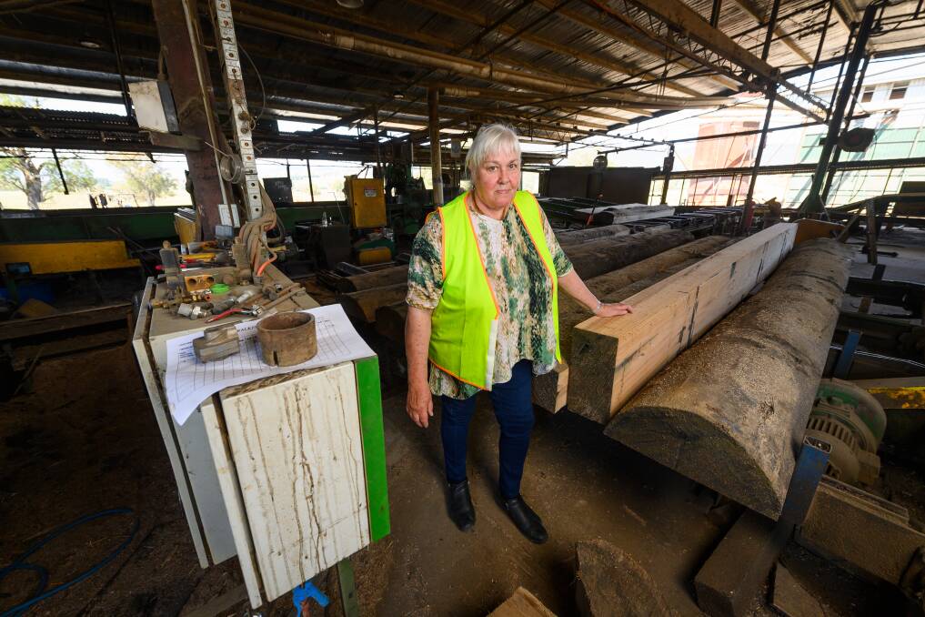 Rhonda Witter with some of the machinery that has fallen silent following the end of production at Corryong's Walkers Sawmill. Picture by Mark Jesser