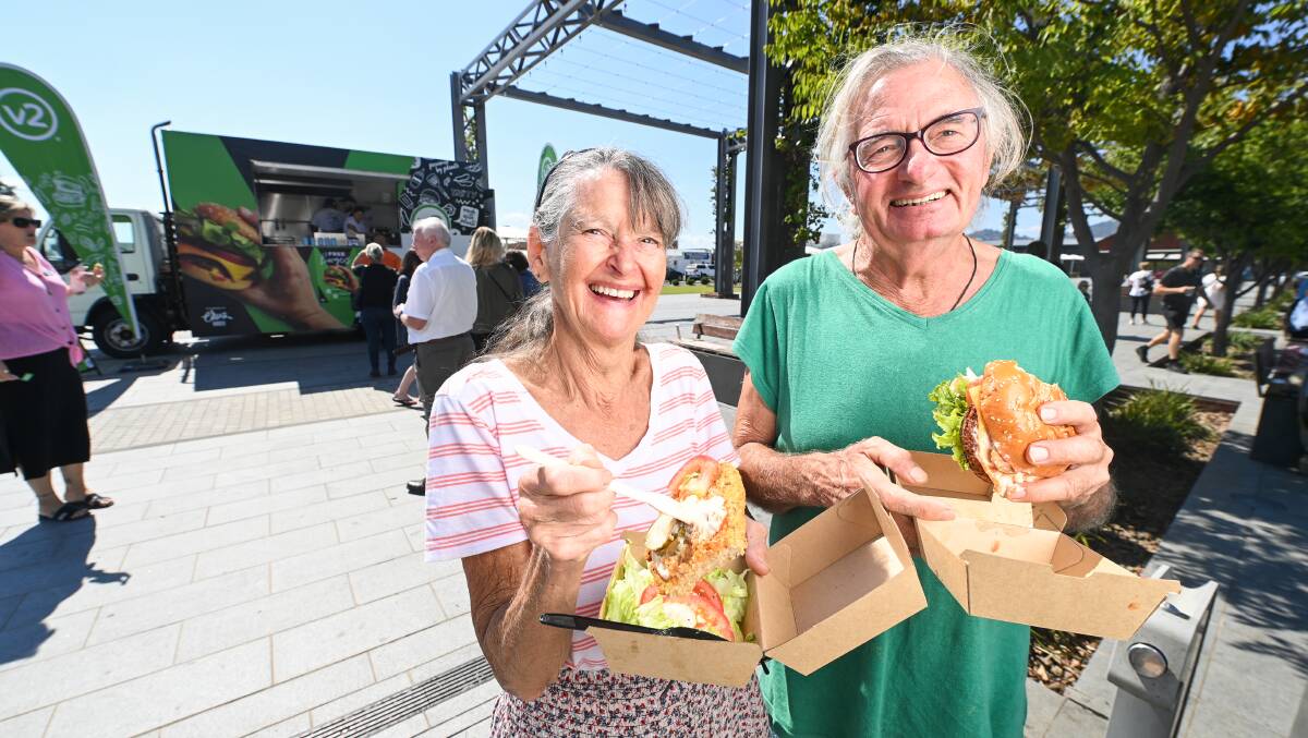 Happy consumers: Irene Hammond and Mel Edwards, who stopped in Wodonga en route from northern NSW to Adelaide, sample v2food burgers in Junction Place. Picture: MARK JESSER
