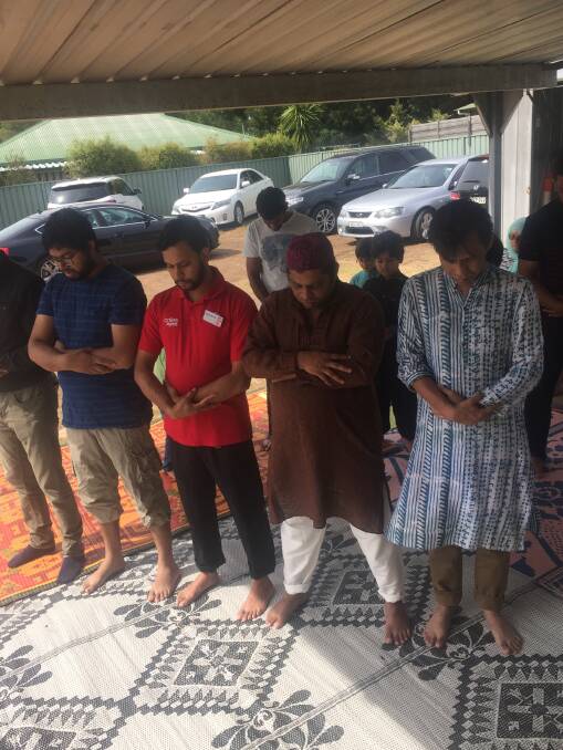 Devout: Muslims from Albury-Wodonga prayer outside the mosque at Lavington on Friday afternoon.