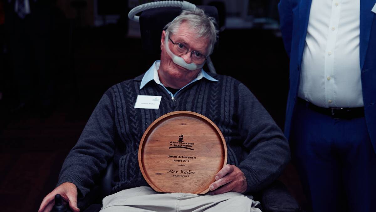 Special occasion: Graham Walker with the platter which he received on behalf of his father Max for lifetime achievement in the forestry industry.