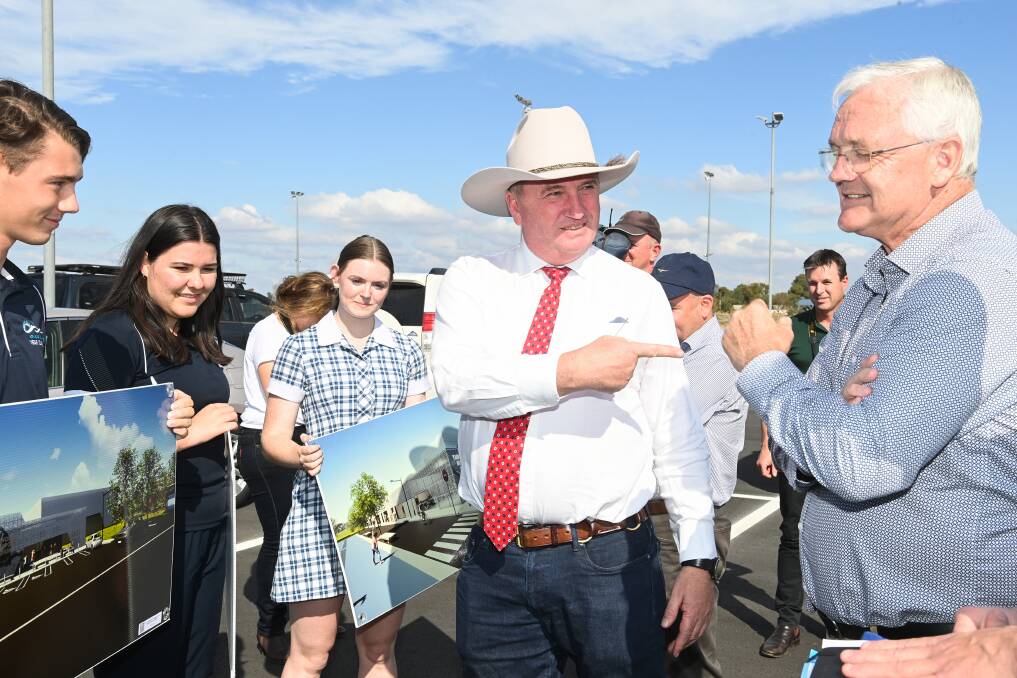 He's the man: Deputy Prime Minister Barnaby Joyce points to Nicholls MP Damian Drum as Yarrawonga high school students hold images of the town's new stadium which has been funded by three levels of government. Picture: MARK JESSER