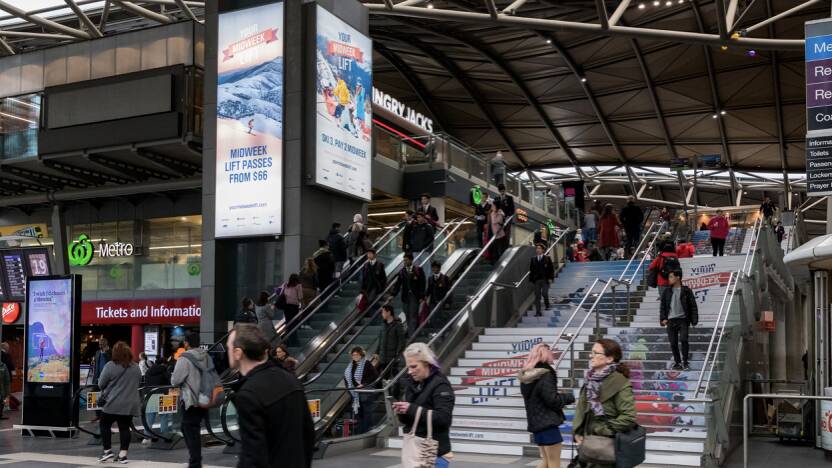 In their sights: Midweek snow breaks are promoted on illuminated signs and steps at Melbourne's Southern Cross railway station.