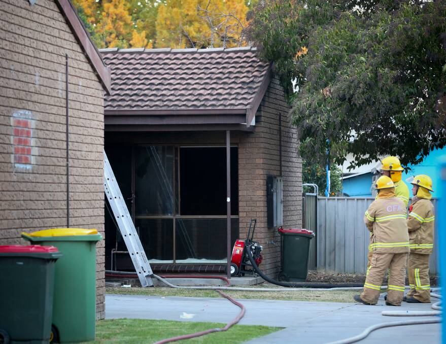 Gutted: Firefighters look into a unit in South Street, Wodonga, which had its interior destroyed in a suspicious fire on Tuesday afternoon. 