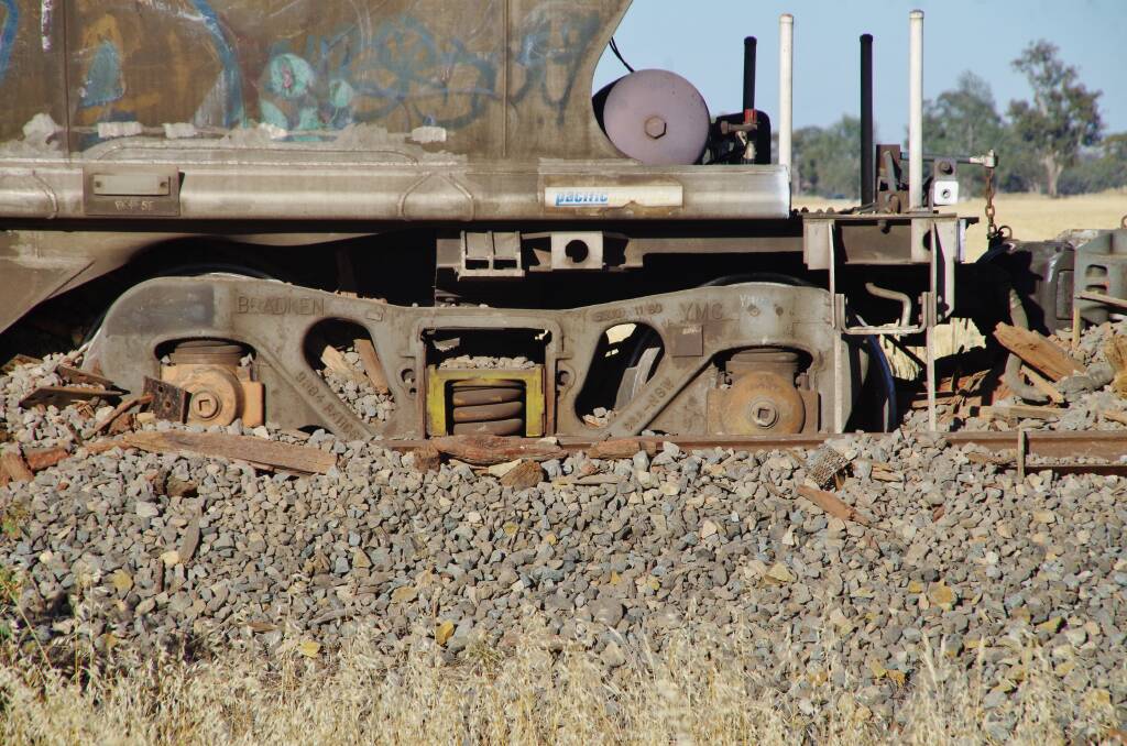 Bogged: Bogies sunk into the track ballast after a grain train derailed south of Yarrawonga on Monday. Picture: KOBEY DIAMOND