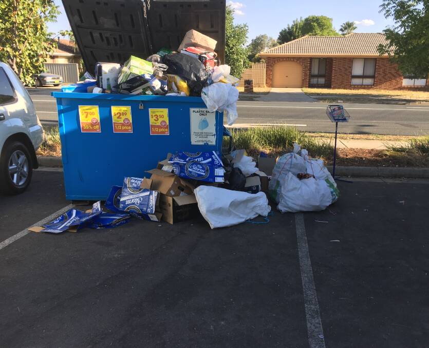 Overflow: The bin outside Springdale Heights IGA supermarket after 5pm on Wednesday. Grocer Bob Mathews says despite daily collection container deposit-related rubbish is regularly spilling from the bin by early afternoon.