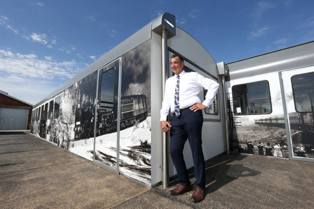 History in images: Developer Clinton Williams with Wodonga rail photographs plastered on replica carriages at Junction Square. Picture: KYLIE ESLER