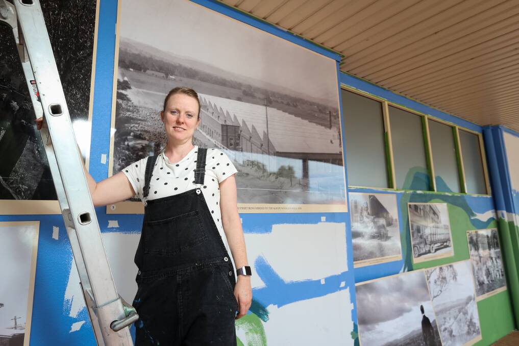 Scaling up interest: Lisa Goff stands in front of a favourite photo which shows the former Amatex textile factory at the southern end of East Albury. Picture: JAMES WILTSHIRE