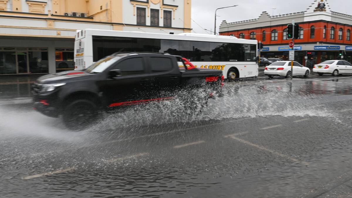 Albury's Dean Street became a splash for motorists on Monday afternoon when a downpour left water across the thoroughfare. Picture by Mark Jesser.