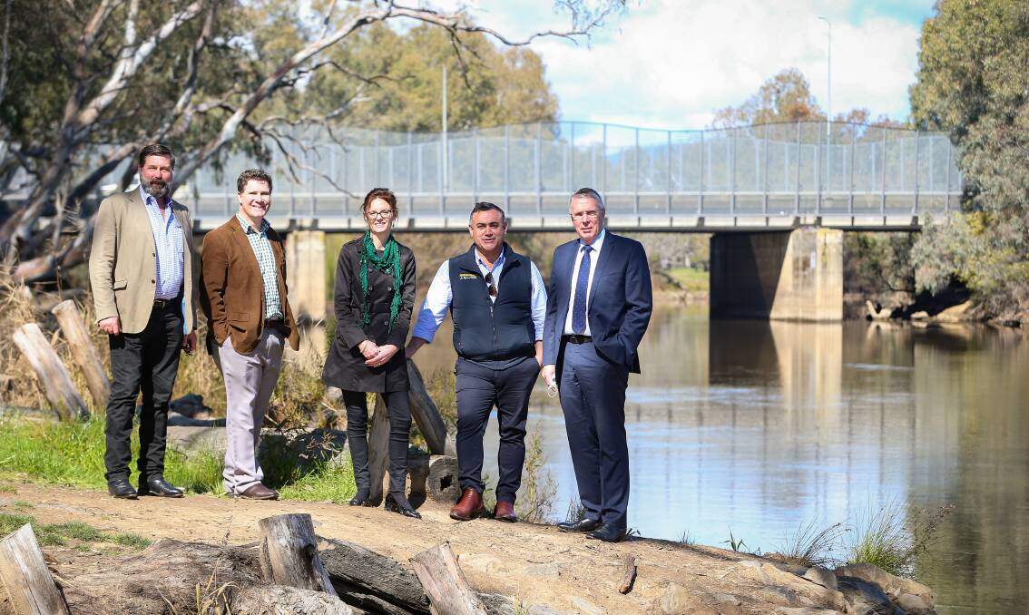 Bridging the gap: Member for Benambra Bill Tilley, member for Albury Justin Clancy, member for Cootamundra Steph Cooke, NSW Deputy Premier John Barilaro and Victorian Nationals leader Peter Walsh on the banks of the Murray River downstream from Albury's Union Bridge on Tuesday morning. Picture: JAMES WILTSHIRE