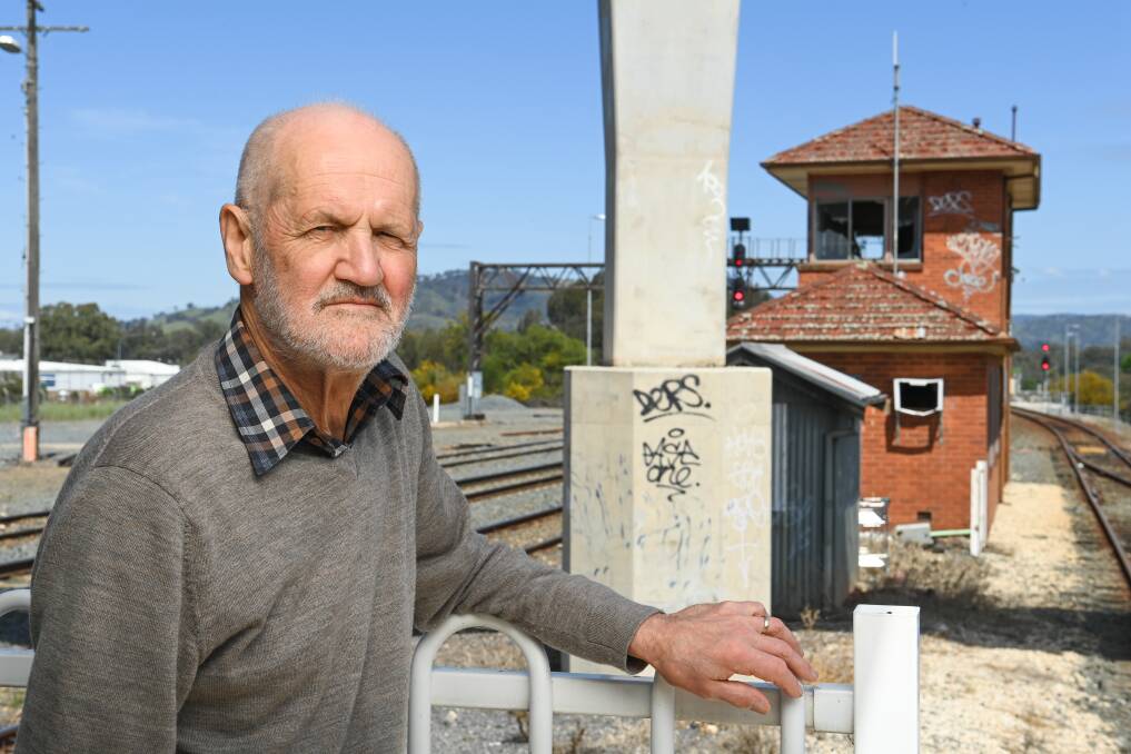  Blight: David Thurley with the defaced signal box near Albury railway station. Picture: MARK JESSER