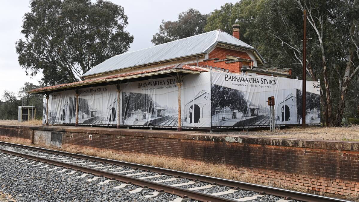 A giant photograph dating from more than a century ago now adorns a fence placed around the Barnawartha railway station. The platform was last a stop-off point for passengers in 1985. Picture by Mark Jesser.