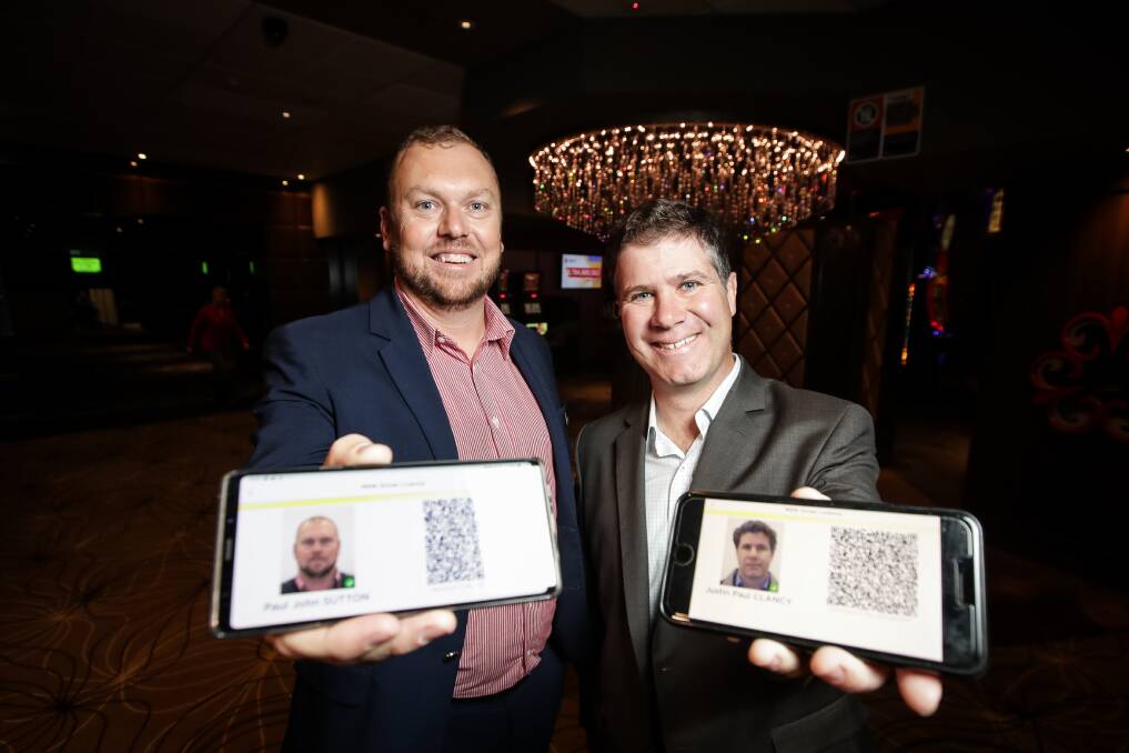 From card to screen: Service NSW regional manager Paul Sutton and member for Albury Justin Clancy show how their digital driver's licences appear on their mobile phones. Picture: JAMES WILTSHIRE