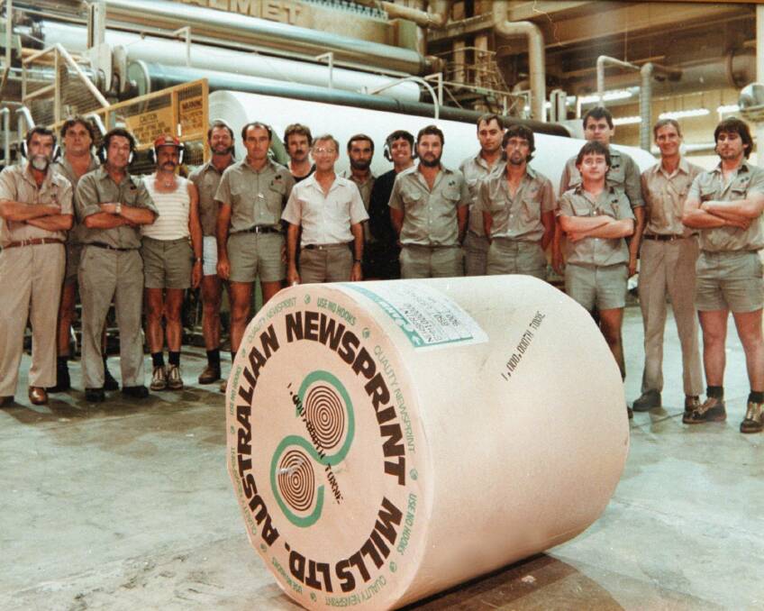 Special roll: Workers with the one millionth tonne of newsprint to come off the production line at the Ettamogah factory.
