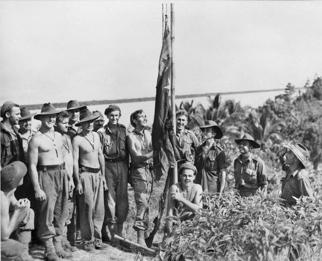 Flashback: The Australian War Memorial featuring solidiers from the 9th Division landing at Tarakan in May 1945 and saluting a flag tied to a bamboo pole.