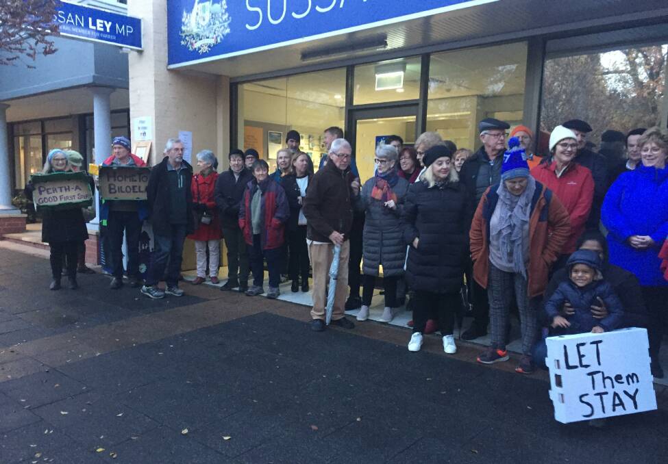 Taking a stand: Supporters of the Sri Lankan family previously detained on Christmas Island and now in Perth stand outside MP Sussan Ley's Albury office.