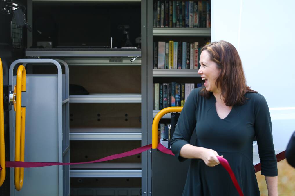 Ceremonial action: Labor government MP Jaclyn Symes snaps the ribbon as Indigo Council's new mobile library van is launched at Beechworth on Monday. Picture: JAMES WILTSHIRE