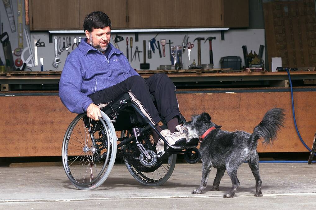 Flashback: Grant Myers in 2003 with his dog Flash after he was diagnosed as a paraplegic. He is keen to see more buildings on the Border made friendly for wheelchairs, citing the Regent Cinema in Albury as one that was hard to enter. 