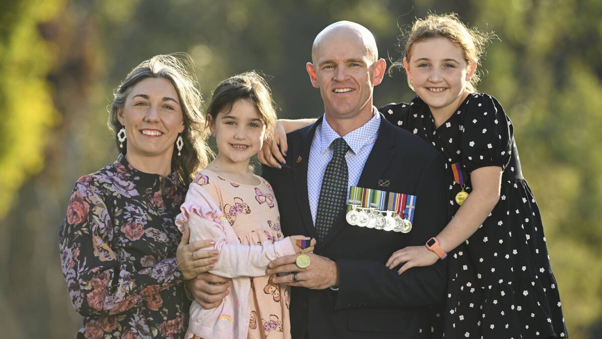 Warrant Officer 2 Jesse Sutherland with his wife Bobbie-Lee and daughters Sophie, 6, and Jasmine, 8, who have their medals recognising their status as defence force children. Picture by Mark Jesser 