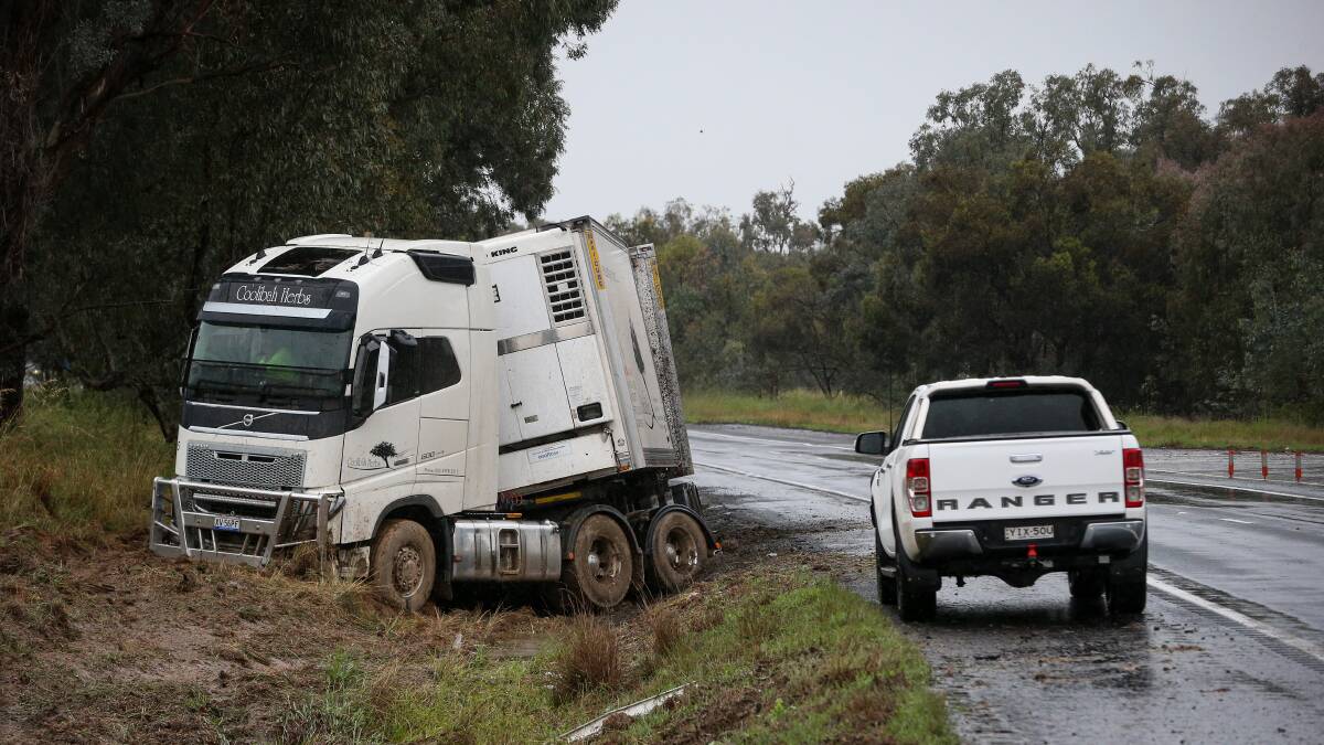 Sticky situation: This semi-trailer was left stuck in mud after sliding off the Hume Highway near Holbrook on Friday morning. Picture: JAMES WILTSHIRE