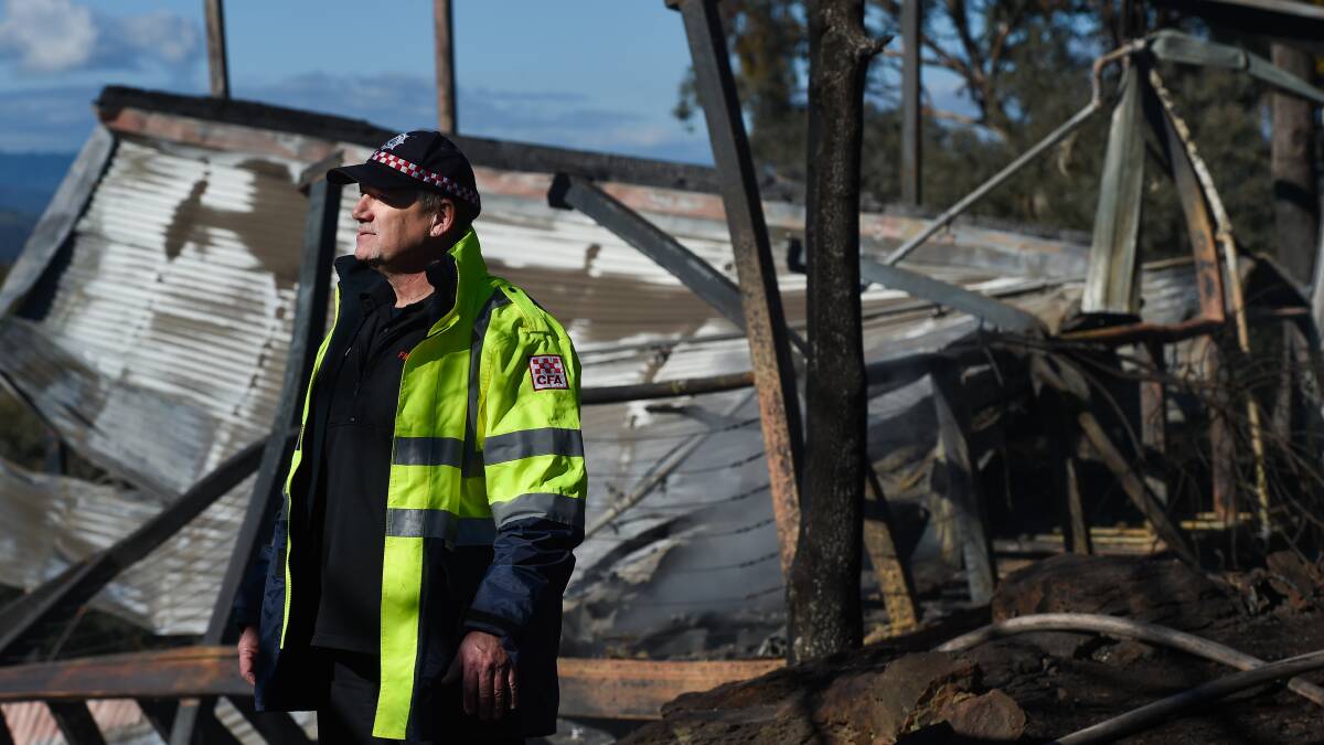 Grim sight: CFA district 23 operations officer Trevor Logan stands in front of what was the master bedroom of the timber and brick house.