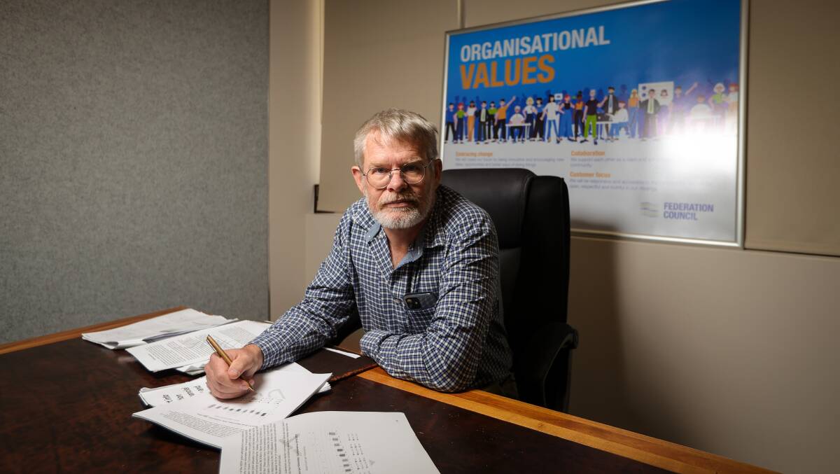 Professor Joseph Drew at the Corowa headquarters of Federation Council with papers that form his draft report looking at sustainability. Picture by James Wiltshire 