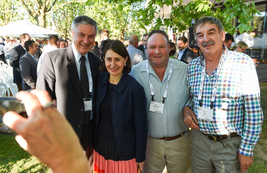 Photo time: Premier Gladys Berejiklian poses for a picture with Greg Aplin and Corowa councillors Shaun Whitechurch and Norm Wales after formalities at the opening of the local government conference. Picture: MARK JESSER