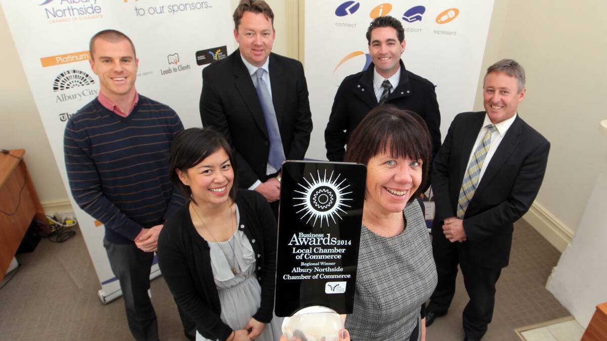Flashback: Kathie Heyman in 2014 when the chamber won a regional award. She is standing in front of Carrick Gill-Vallance, Maria Tolentino, Jason Croker, Scott Mann and Greg Wood. 