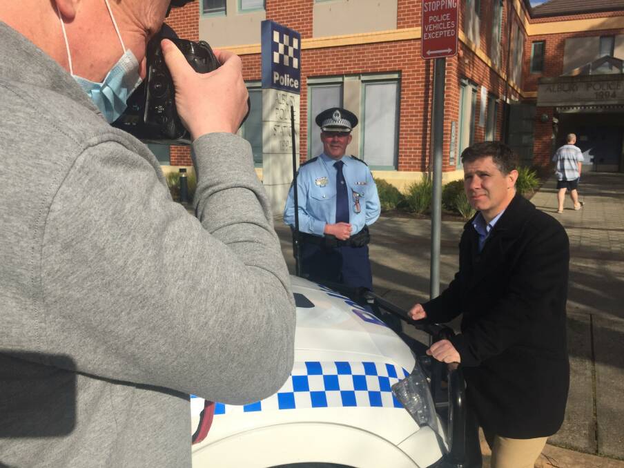 On the beat: Border Mail photographer James Wiltshire captures Murray River police region chief Superintendent Paul Smith and member for Albury Justin Clancy following their joint media conference on Friday.