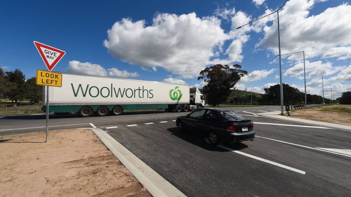 Zooming past: A truck passes along the Hume Freeway while a car waits to cross at the McKoy Street intersection in west Wodonga.