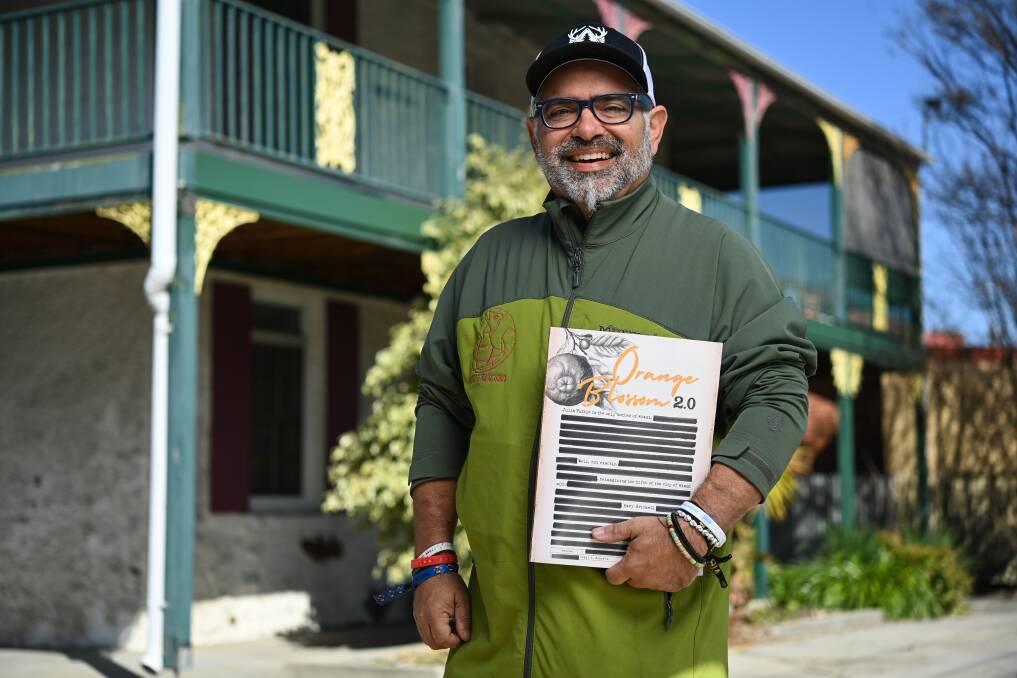 Cesar Becerra with his book outside the Smollett Street property which was used as stables by the Brickells. However, at that time it did not have a verandah. Picture by Mark Jesser. 