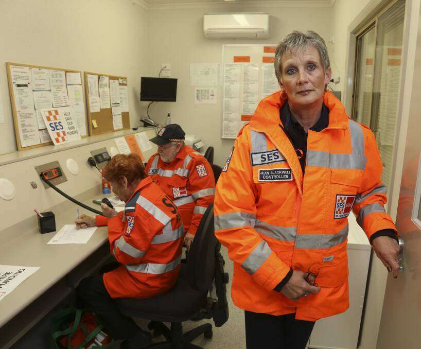 Not happy: Tallangatta SES controller Jean Blackwell in the unit's control room with Elsie Hamlin and Stephan Bornholm on the radio. They want Towong Council's funding cut to be reversed. Picture: ELENOR TEDENBORG