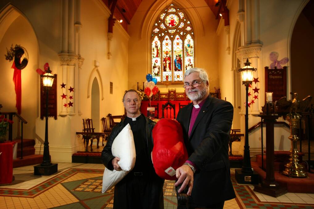 Colleagues in church: Father Peter MacLeod-Miller and Bishop John Parkes at St Matthew's in Albury in 2013. The pillow and sleeping bag reflect their concerns about homelessness. 