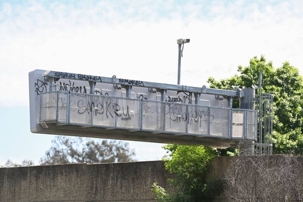 Eyesore: Scrawls daubed over the back of an overhead sign along the Hume Highway in South Albury. Picture: MARK JESSER