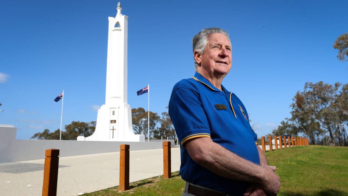 Showing his colours: Graham Docksey at the Albury war memorial which currently displays the Australian and New Zealand flags.