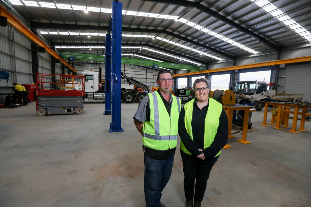 Lift off: The owners of Border Crane Consultants Jason and Melissa Barry inside their giant new workshop at Baranduda. Cranes of all sizes and types can be serviced and custom made in the shed. Picture: TARA TREWHELLA