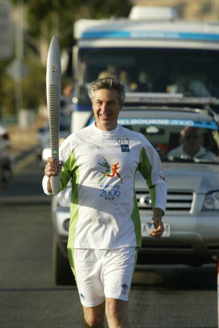 Baton bearer: Greg Aplin takes hold of the Commonwealth Games symbol of harmony during his tour through the Border ahead of the 2006 event in Melbourne.