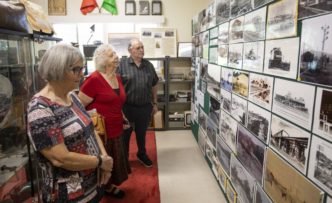 Look into the past: Mandy, Sandra and Bill Lalor take in the wall of railway photographs at the new Wodonga Historical Society rooms. Picture: ASH SMITH