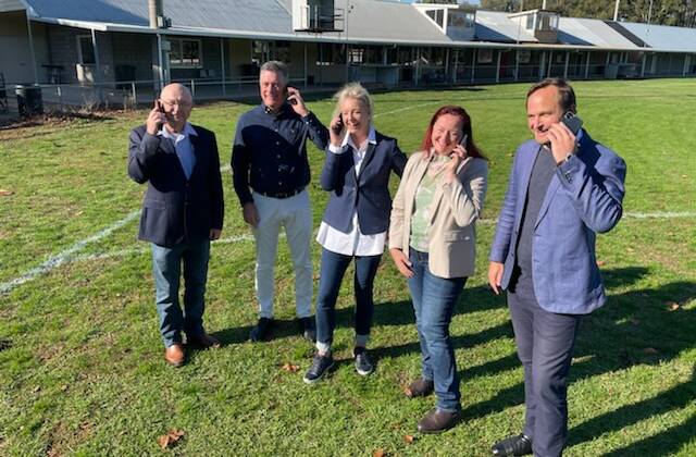 Phones up for better coverage: Wangaratta councillors Harvey Benton and Dean Rees with Senator Bridget McKenzie and Coalition candidates for Indi Liz Fisher and Ross Lyman at Tarrawingee on Sunday.